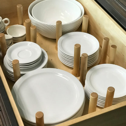 Dishes Stacked in a Drawer Organized with Drawer Peg System | Canyon Creek Cabinet Company