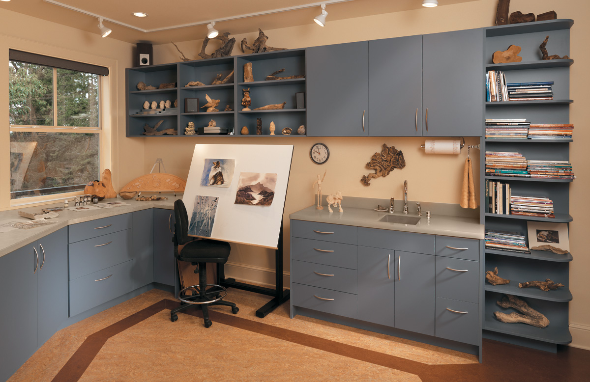 Sink Area with Blue Cabinets Decorated with Books and Assorted Artifacts | Canyon Creek Cabinet Company