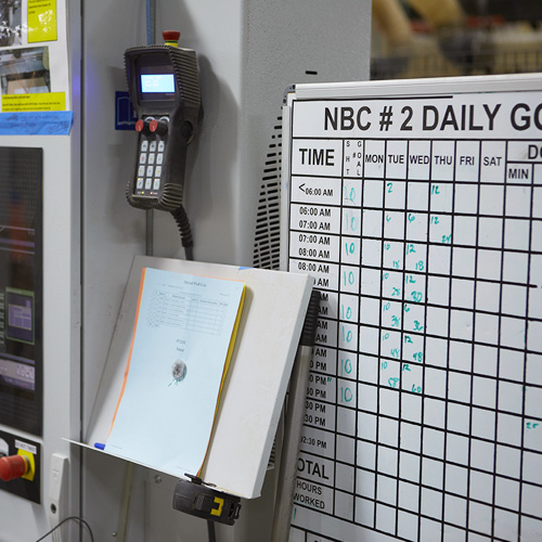 Calendar on a Whiteboard with Stack of Papers Nearby | Careers | Canyon Creek Cabinet Company